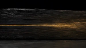 dark layers with a stream of gold that disperses into the surrounding tissue blurring it